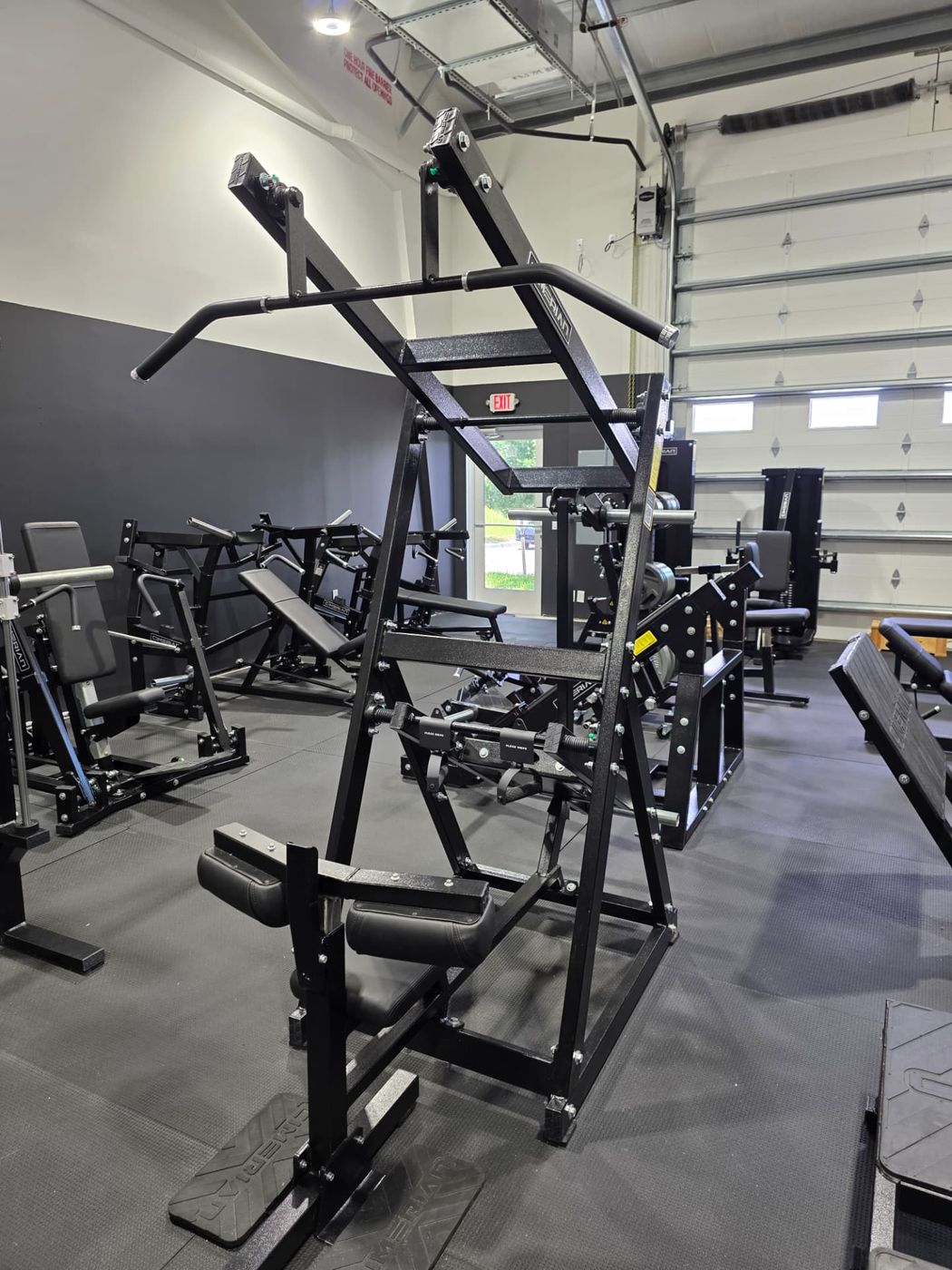Plate-loaded rack station in the private gym